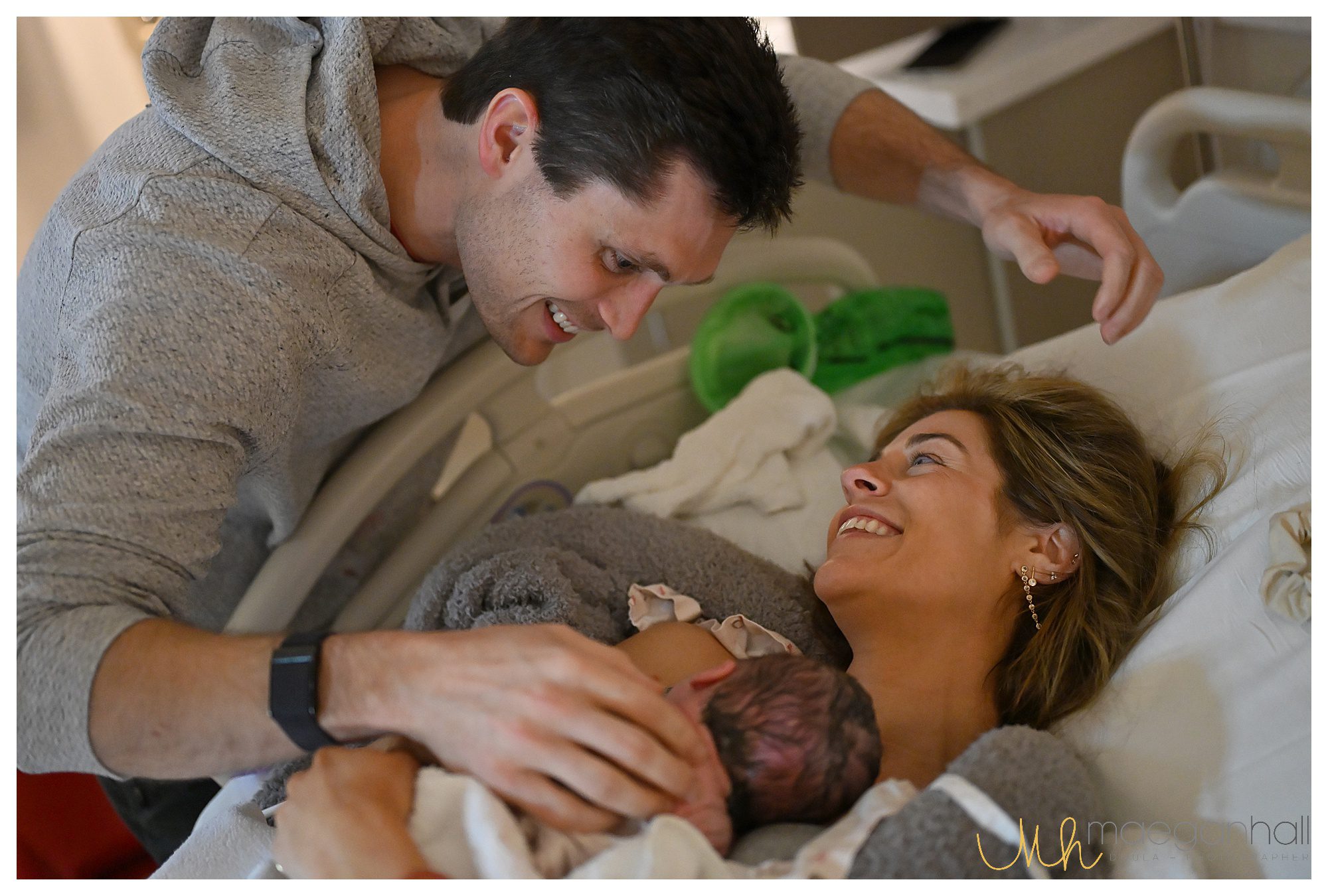 Partner wiping away tears after witnessing the birth of their child
