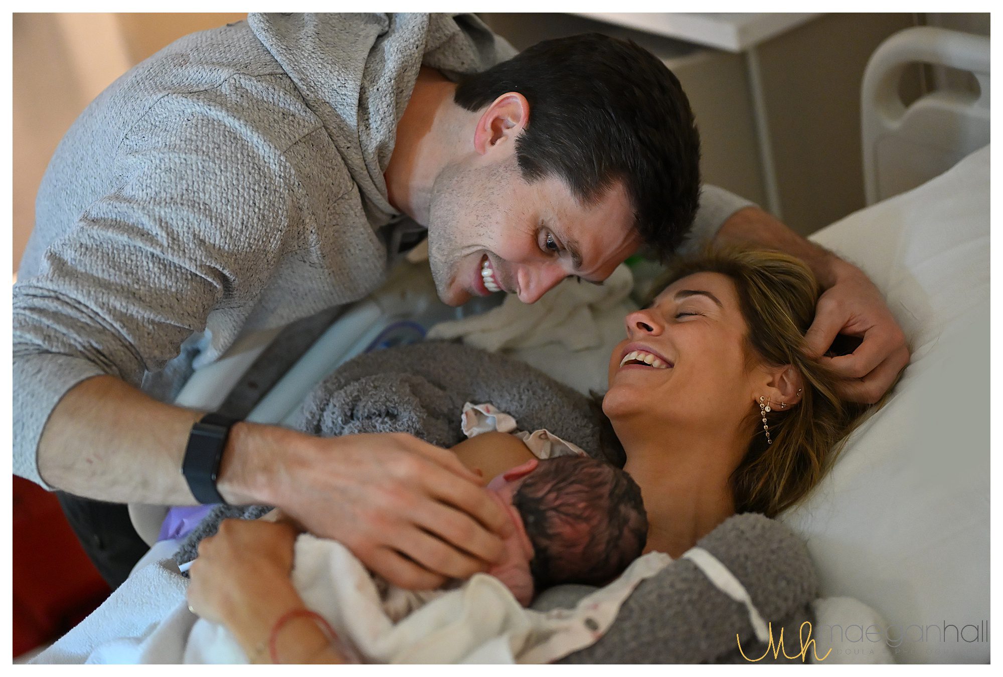 Dad smiles at new baby after unmedicated birth